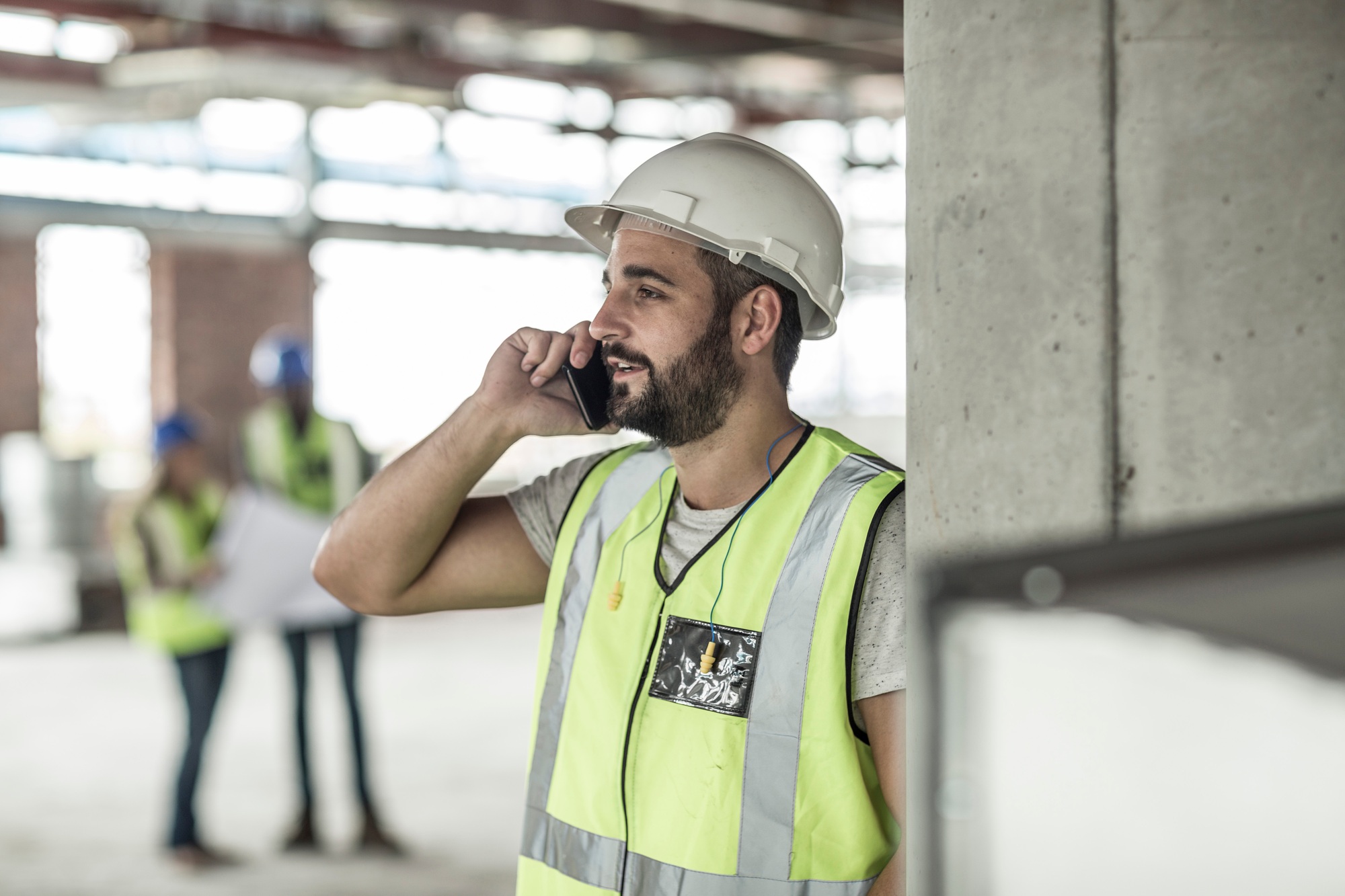 Construction worker on cell phone in construction site